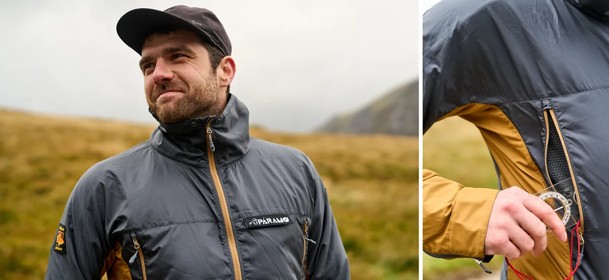 Man in windproof in the rain navigating with a compass