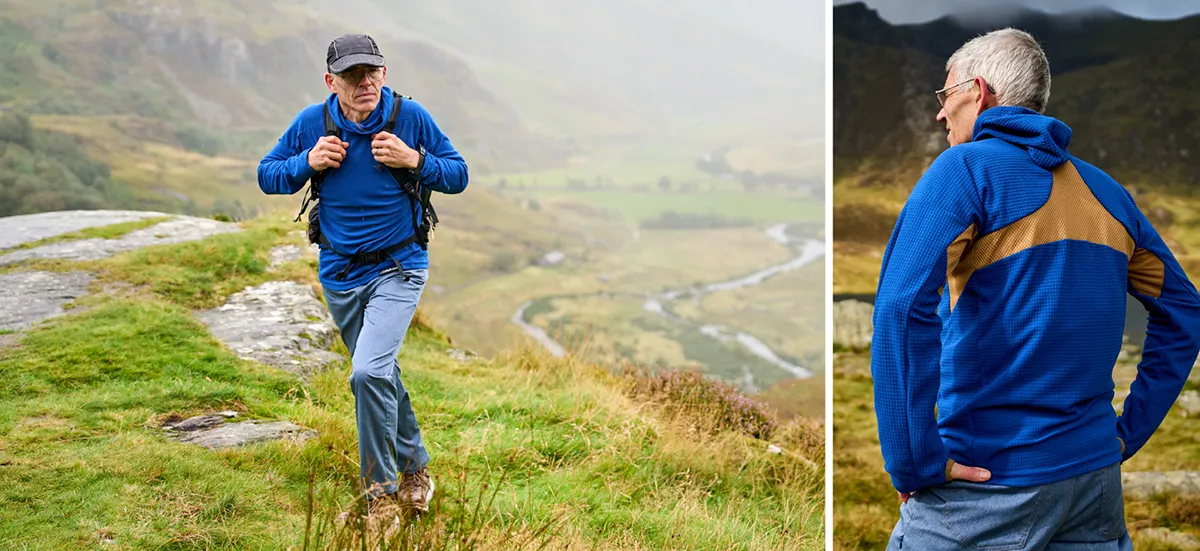 Older Man wearing warm top hiking with a packpack through Snowdonia